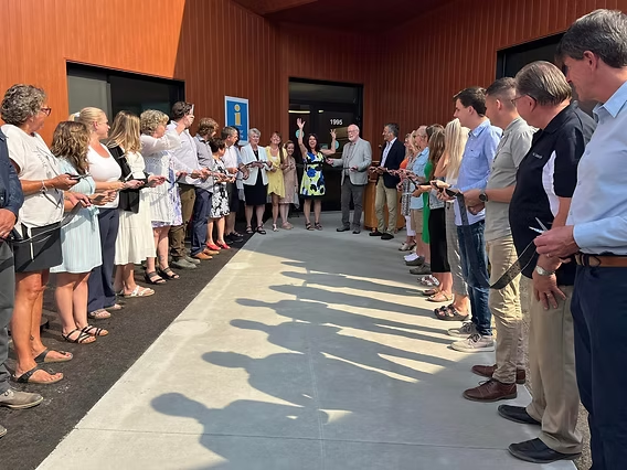 Community members gathered outside The Confluence for the ribbon-cutting celebration